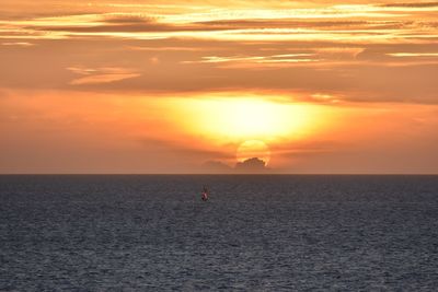 Scenic view of sea against orange sky
