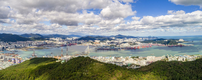 High angle view of townscape by sea against sky