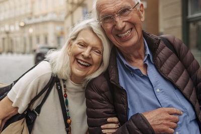 Portrait of happy senior couple in city