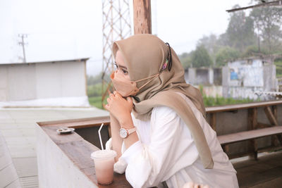 Low section of young woman standing in city
