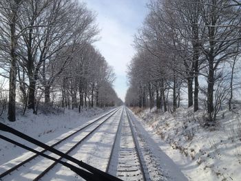 Road passing through snow covered landscape