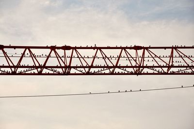 Low angle view of silhouette bridge against sky