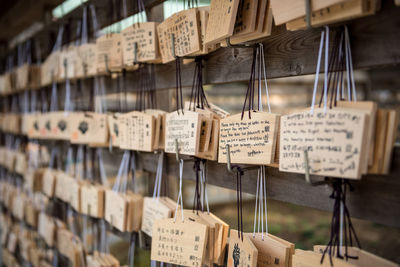 Close-up of text hanging on wood outside temple