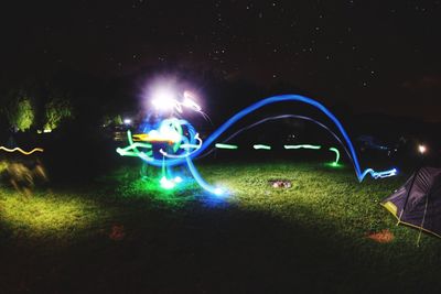 Illuminated ferris wheel at night