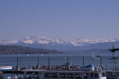 Scenic view of sea and mountains against sky