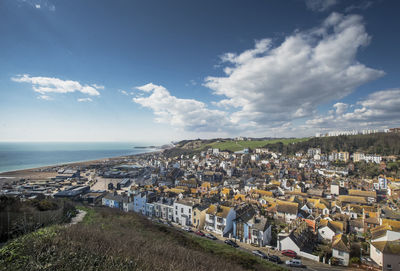 High angle view of townscape by sea against sky