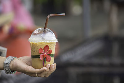 Close-up of hand holding drink