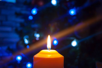 Close-up of lit candles in the dark