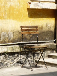 Empty bench in abandoned chair