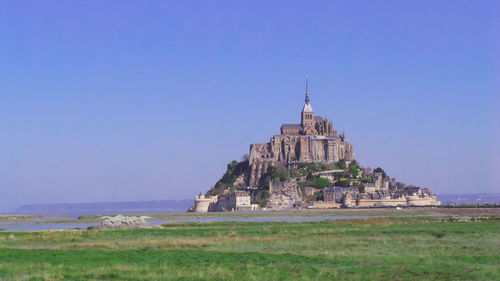 View of temple building against clear blue sky