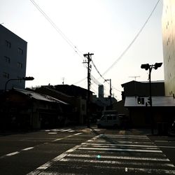 Vehicles on road against buildings in city