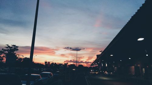 Traffic on road against cloudy sky at dusk