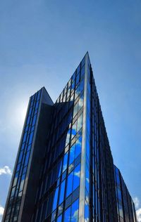 Low angle view of modern building against clear blue sky