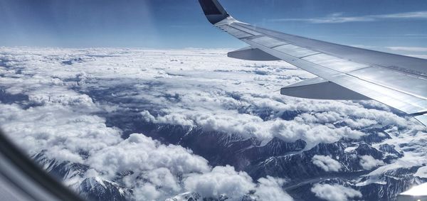 Aerial view of airplane flying in sky