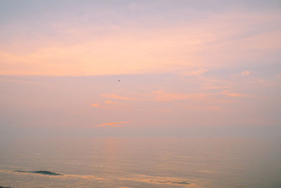 Smoky pink sky sunset over water, ocean