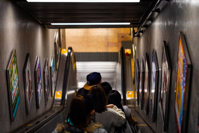 Subway downgoing escalator with people