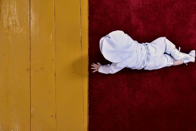 Directly above shot of baby crawling on carpet