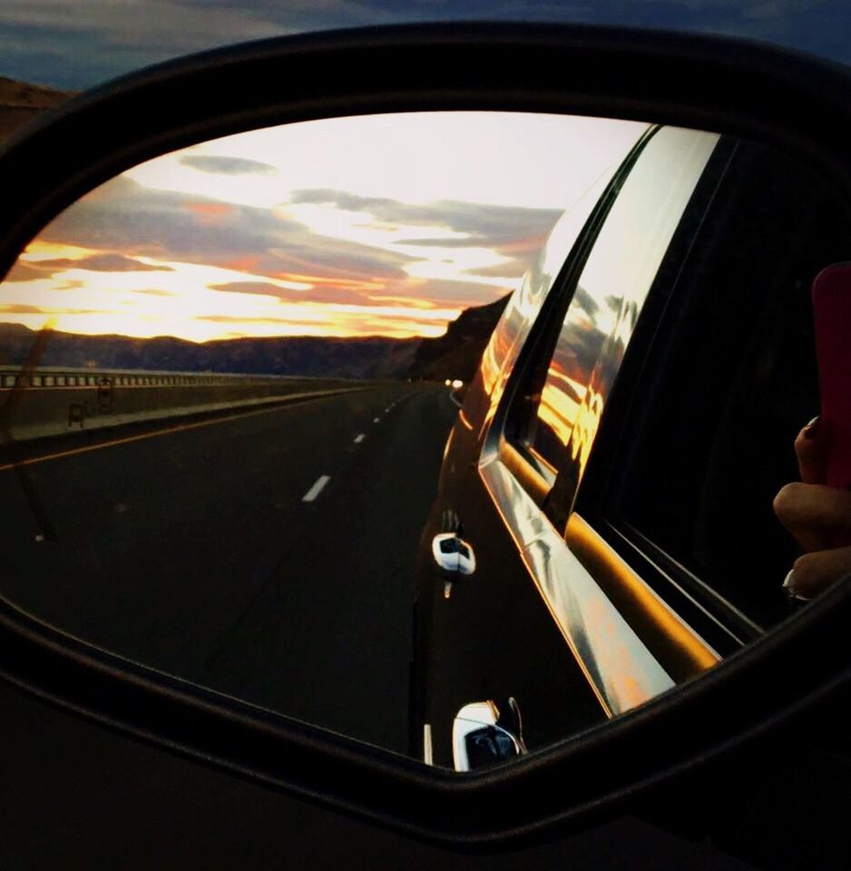 car, land vehicle, window, transportation, human hand, mode of transport, side-view mirror, sky, steering wheel, one person, close-up, day, real people, outdoors, human body part, nature, people