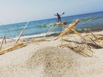 Close-up of sand on beach against sky