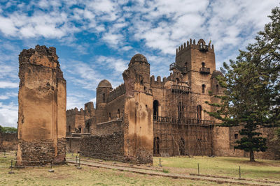 Old ruins of temple against cloudy sky