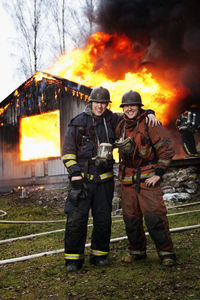 Fire fighters in front of burning buildings