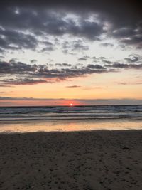 Scenic view of beach against sky during sunset