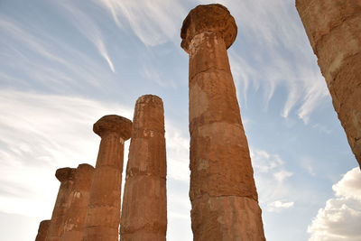 Low angle view of columns at historic site against sky
