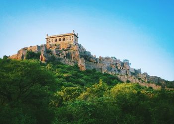 Low angle view of built structure against clear blue sky