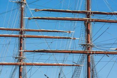 Low angle view of sailboat against blue sky