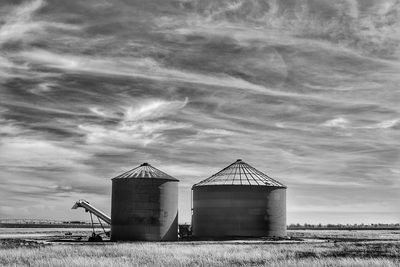 Barn on field against sky