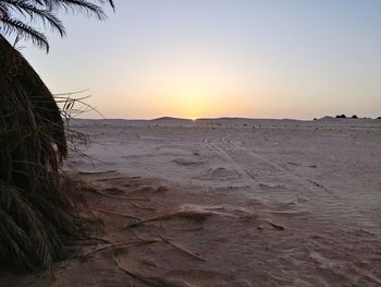 Scenic view of beach against sky during sunset