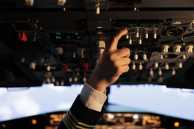 Cropped hand of man using mobile phone