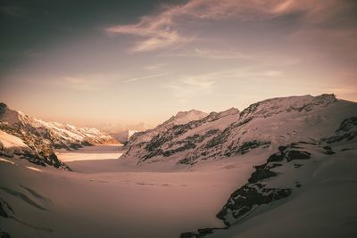Scenic view of snowcapped mountains against sky during sunset