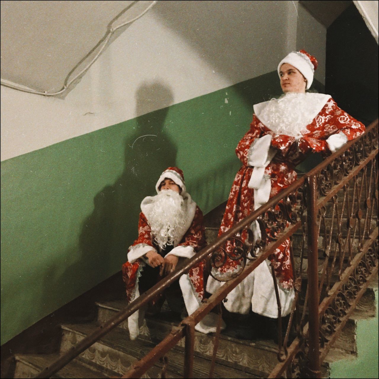 PORTRAIT OF MAN SITTING ON RAILING
