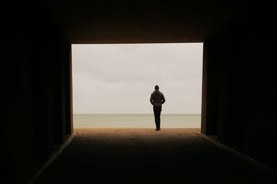 Rear view of silhouette woman walking at beach