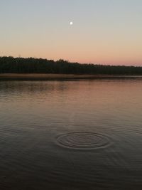 Scenic view of lake against clear sky during sunset