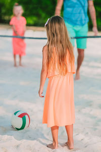 Rear view of women standing on beach