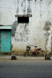 Bicycle on wall against building