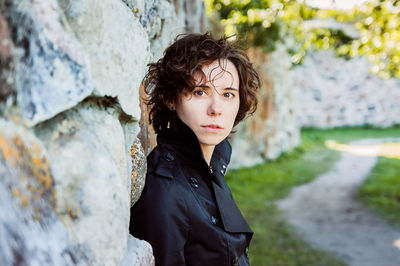 A girl lean on the stone wall of an ancient fortress