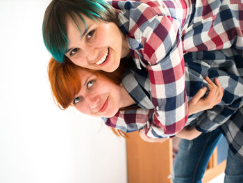 Portrait of smiling lesbian couple at home