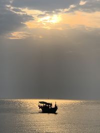 Fishing boat in sea against sky during sunset in kep, southern cambodia. 