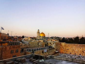 High angle view of buildings against clear sky at sunset