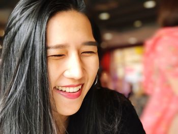 Close-up portrait of smiling young woman