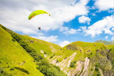 Person paragliding against sky