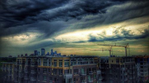 Buildings against cloudy sky