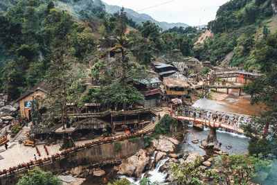 High angle view of bridge over river amidst buildings