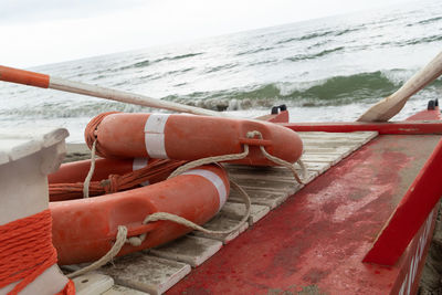 Orange lifebuoys with ropes on a rescue rowing catamaran