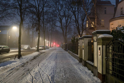 Illuminated street against sky