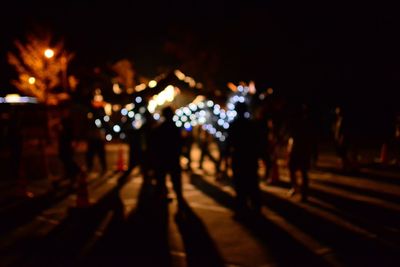 Crowd at illuminated city at night