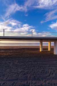 Bridge over beach against sky